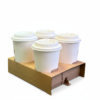 Four white coffee cups in carrier