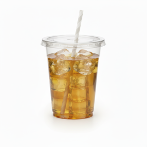 Iced apple juice in transparent plastic cup with white paper straw