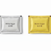 White and brown sugar packets combined